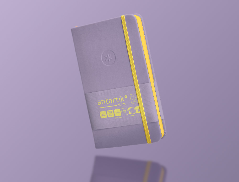 CADERNO COM ELASTICO ANTARTIK NOTES CAPA DURA A6 QUADRICULADO ROXO E AMARELO 100 FOLHAS 80 GR FSC
